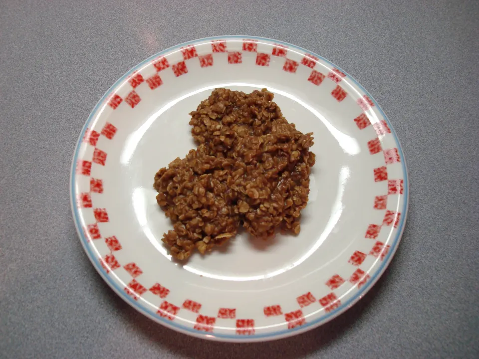 Cookies on a white plate with red and white checked border